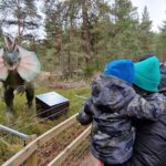 Family look at the dinosaur exhibition at Landmark adventure park Carrbridge