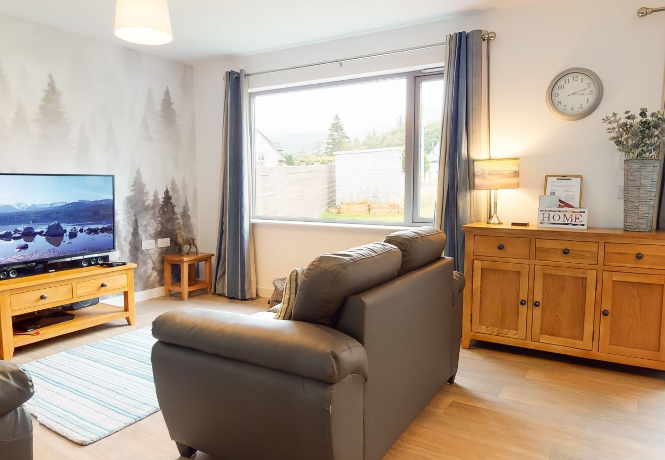 Living space with couches and tv in a Aviemore self catering property