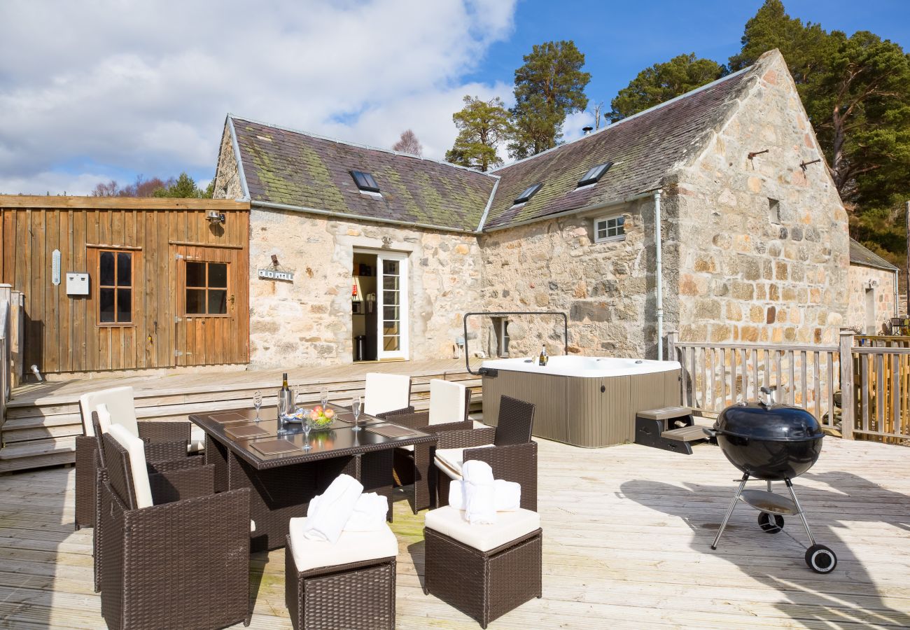 Scottish holiday lodge with outdoor decking area with dining area, bbq and hot tub.