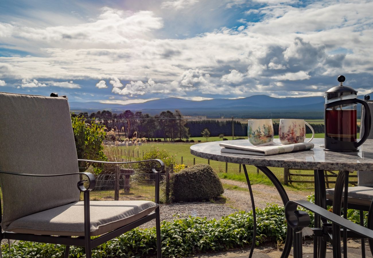 Coffee with view of the Cairngorms at a holiday lodge