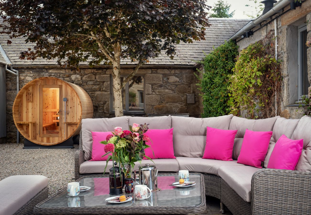 Outdoor furniture and sauna at a holiday lodge in Cairngorms
