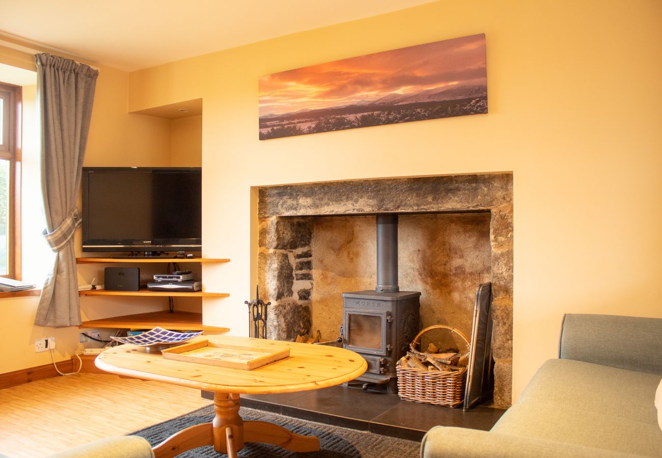 Relax with a seat by the fire at Pilmuir