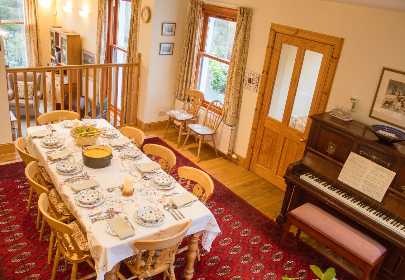 Dining table and piano at Carriden