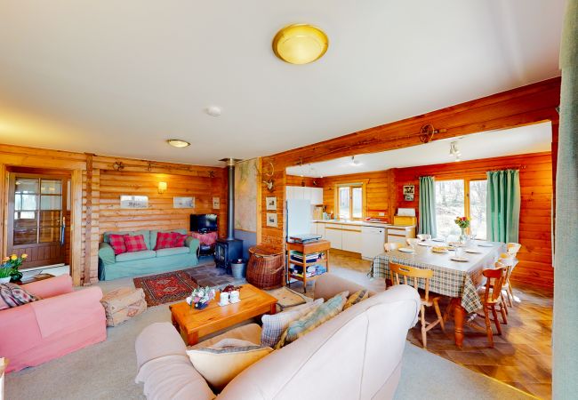 Living room and dining area in a Highland log cabin