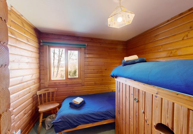 Two single beds in a Scottish log cabin