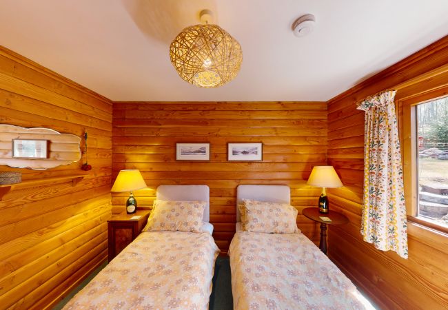 Twin beds in a log cabin near Aviemore