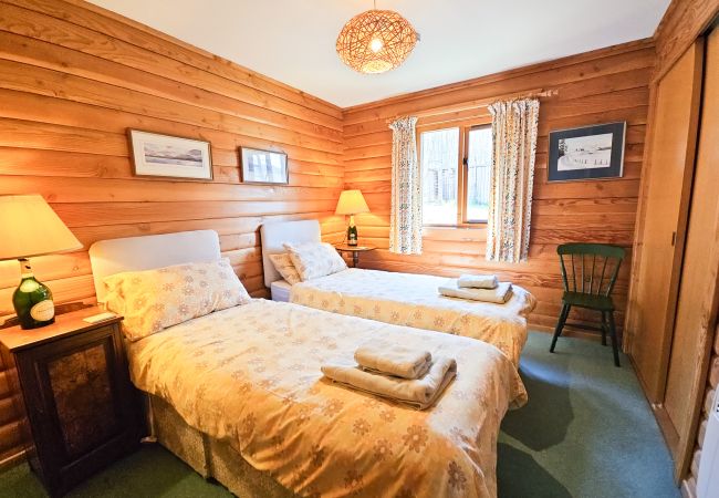 Twin beds in a log cabin in Scottish highlands