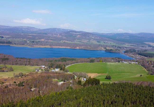 Aerial view of Loch Insh with Balbeag holiday cottage in the foreground