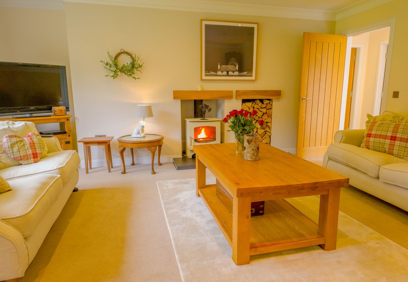 The living room with wood burning stove at The Bellhouse