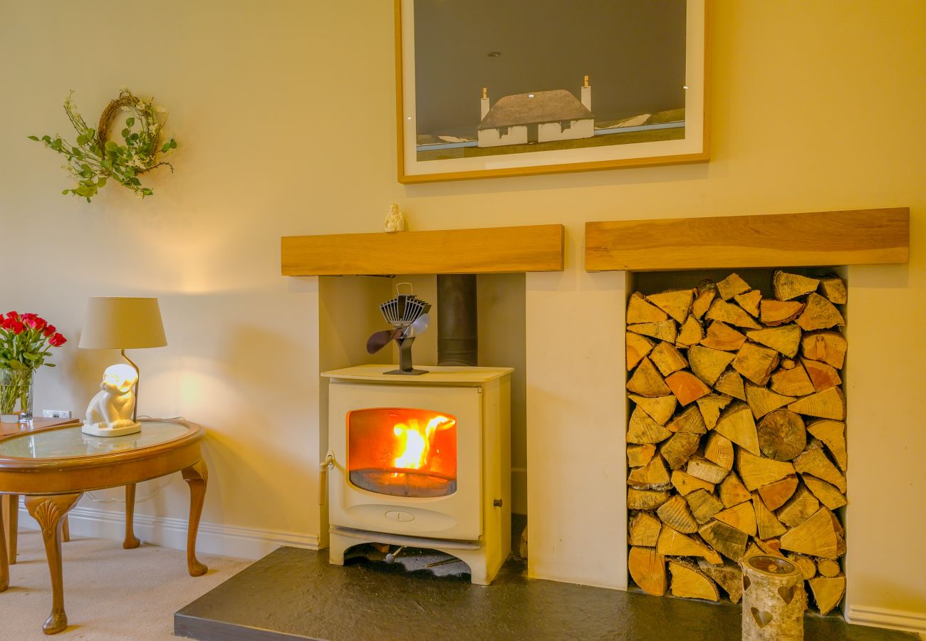 The living room with wood burning stove at The Bellhouse