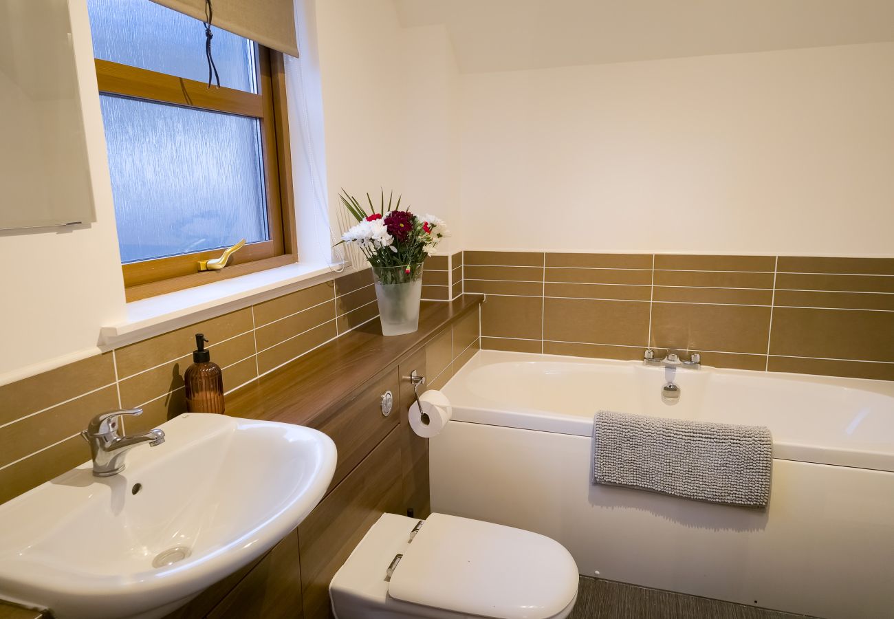 Master bedroom Ensuite with bath and separate shower in an Aviemore holiday home