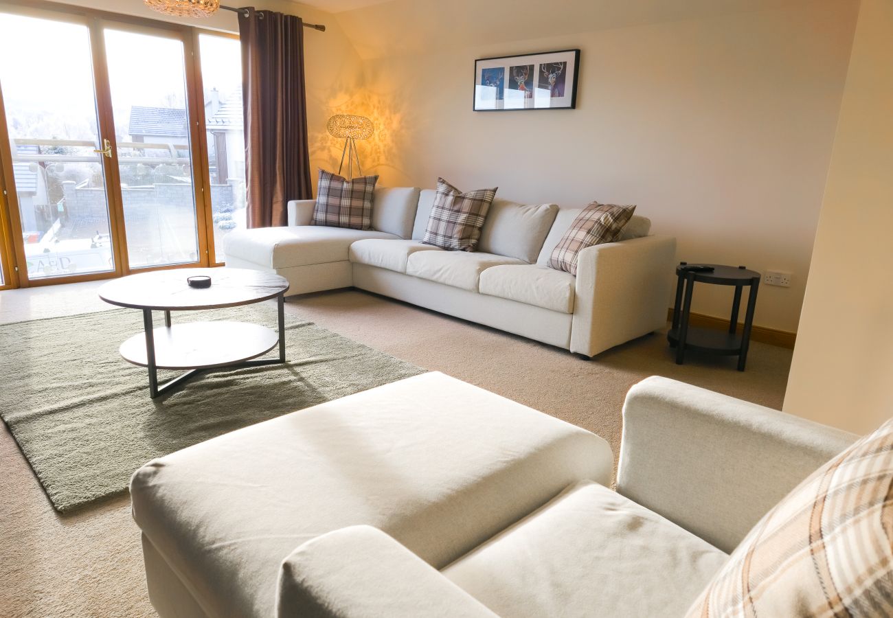 Comfortable bright spacious living room in an Aviemore holiday home.