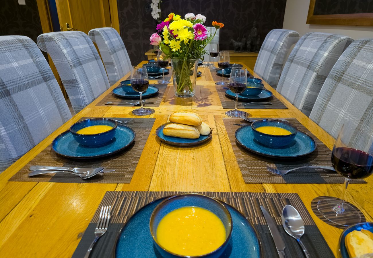 A bright dining area with seating for eight in an Aviemore lodge