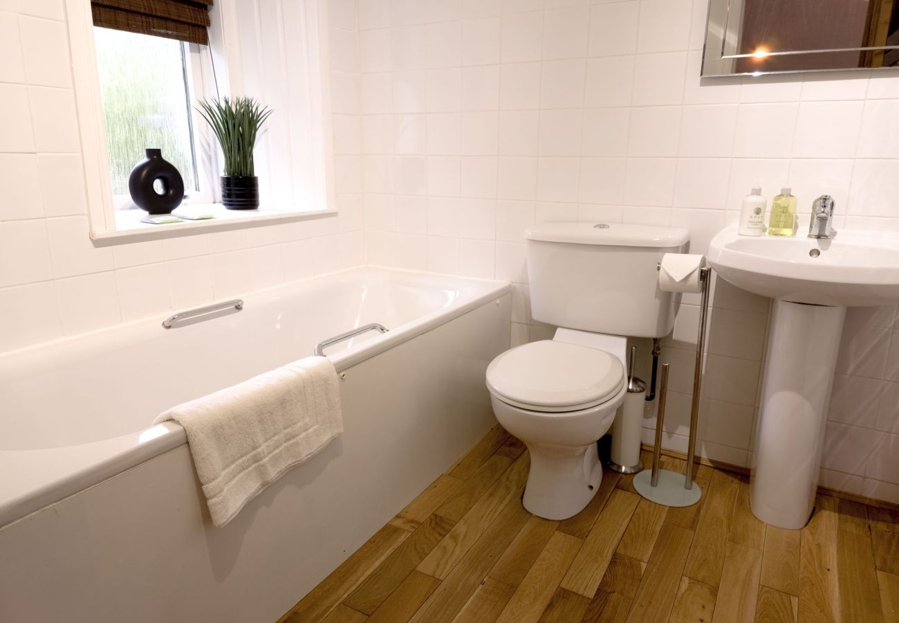 Bathroom with a walk-in shower and bath in a holiday home in Laggan, Scotland