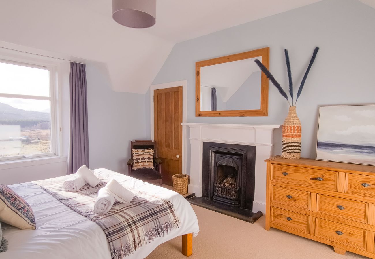 Double bedroom with cozy bedding and natural light in a Laggan holiday home