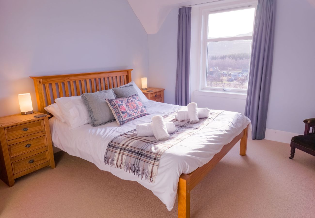 Master bedroom with a comfortable bed and Highland views in Laggan