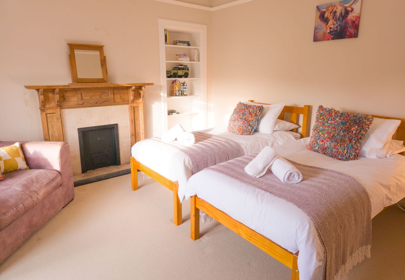 A large downstairs twin bedroom in a highland holiday home