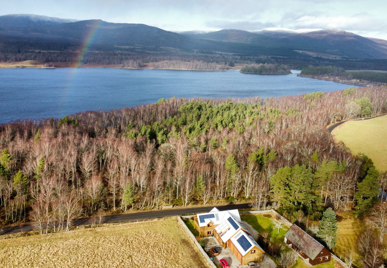 Telford Cottage from the air and loch insh with a rainbow over the loch