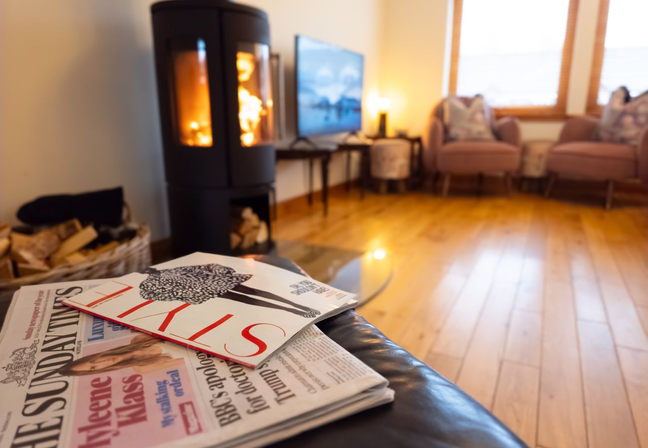 Log burner and magazines in Aviemore holiday home