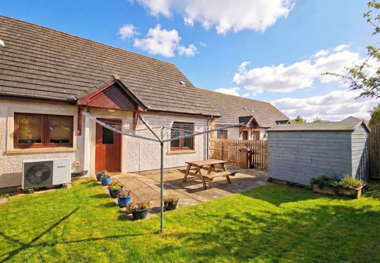 Safe enclosed garden for pets with outdoor picnic bench