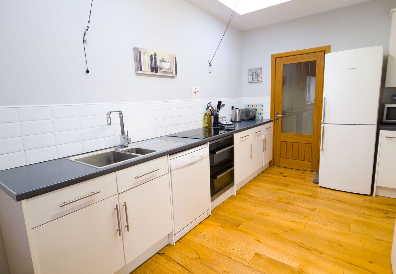 Kitchen with white cabinets and wood flooring