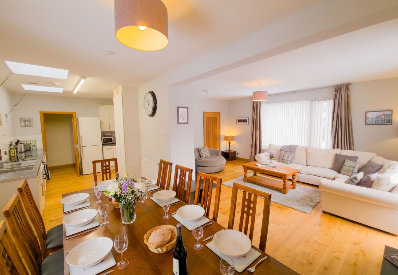Dining table and lounge in open-plan layout
