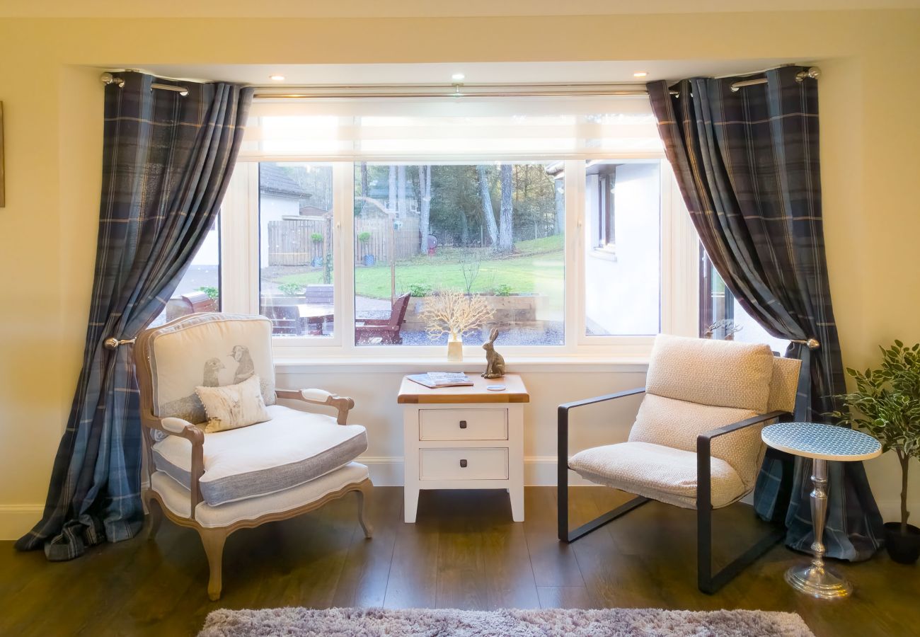 Relaxed and inviting living room with large windows in Tomatin.