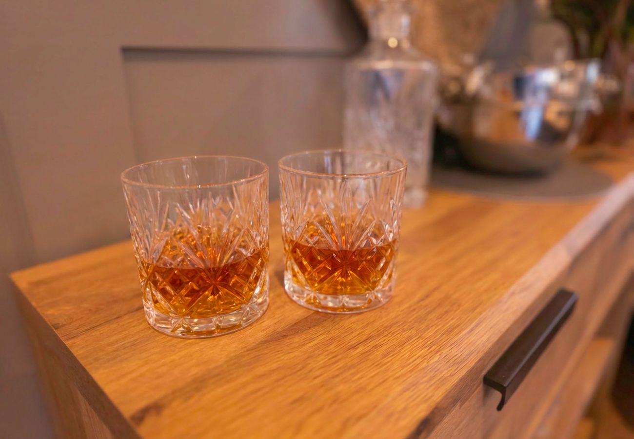 Two glasses of whisky for an evening drink by the log burner.