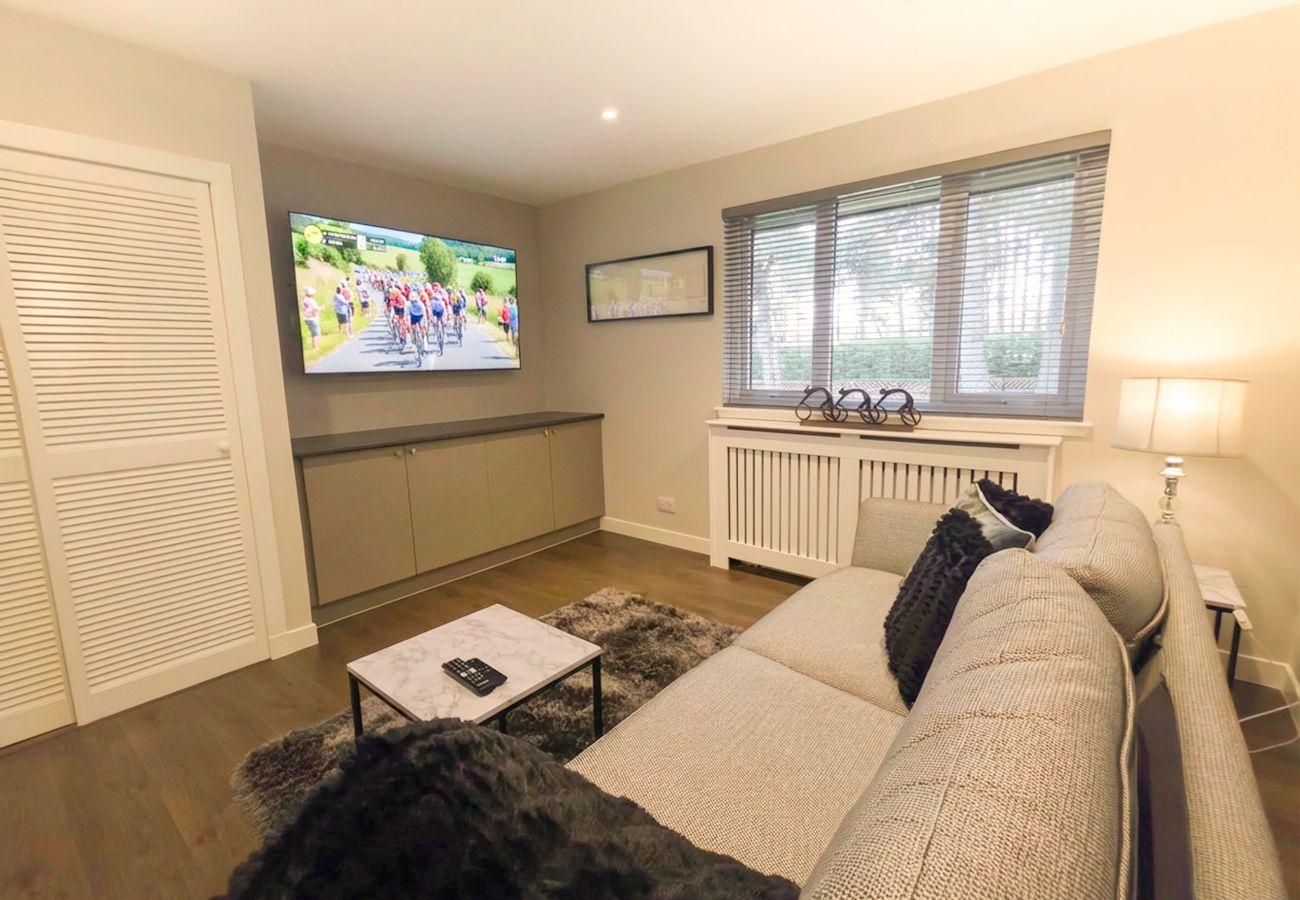 Quiet second living room with comfortable sofa and TV.