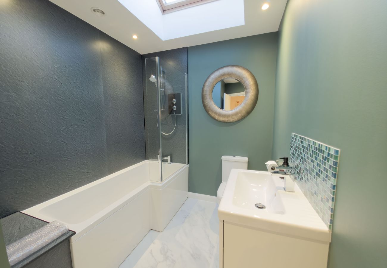 Contemporary bathroom with dark tiles