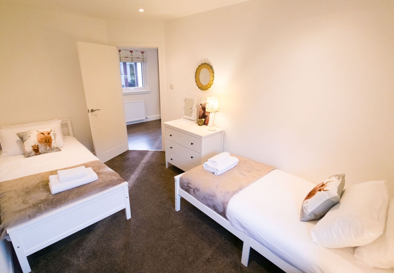 Two single beds in a light and airy twin bedroom setup.