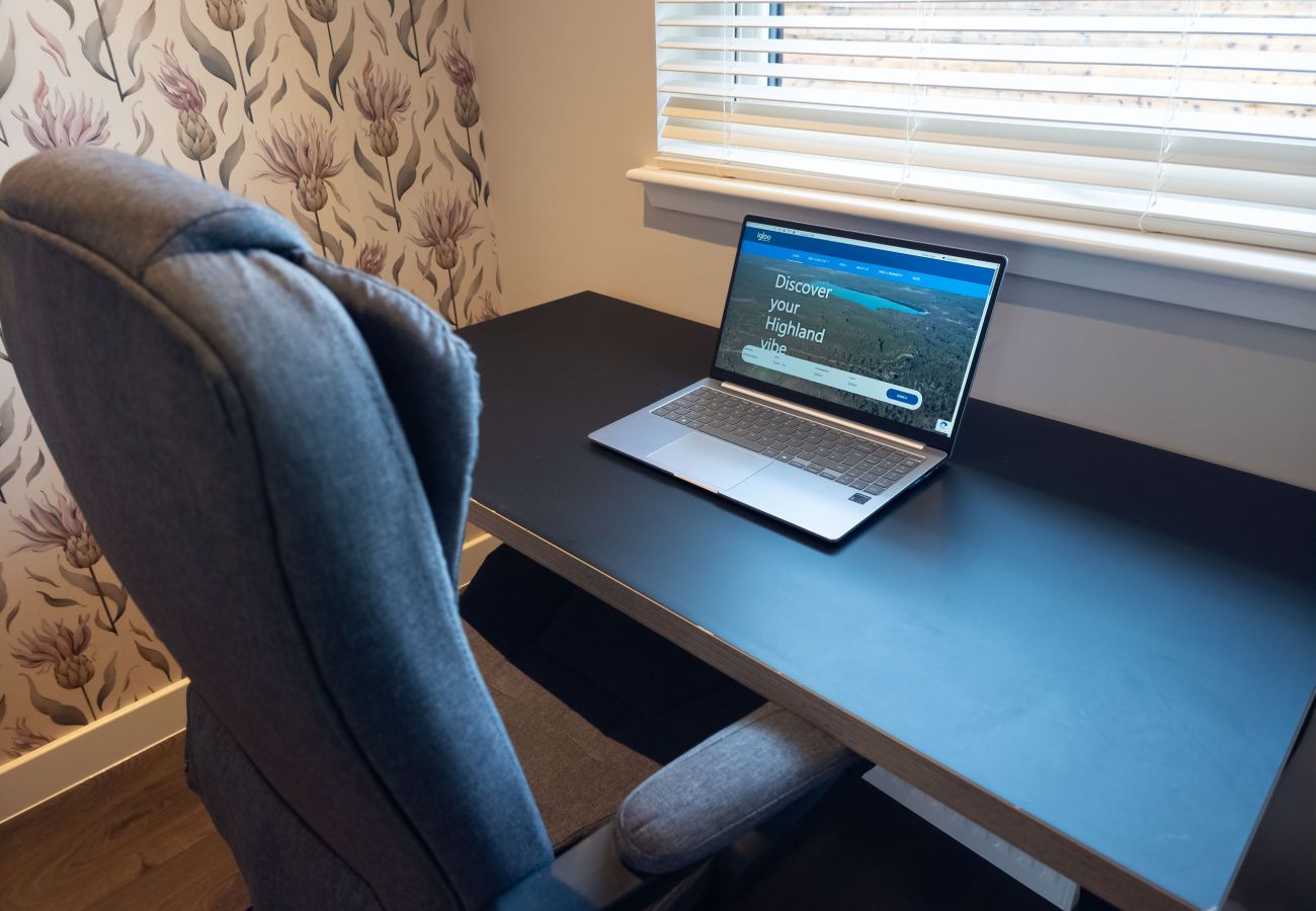 Dedicated desk area with a chair and laptop for working remotely.