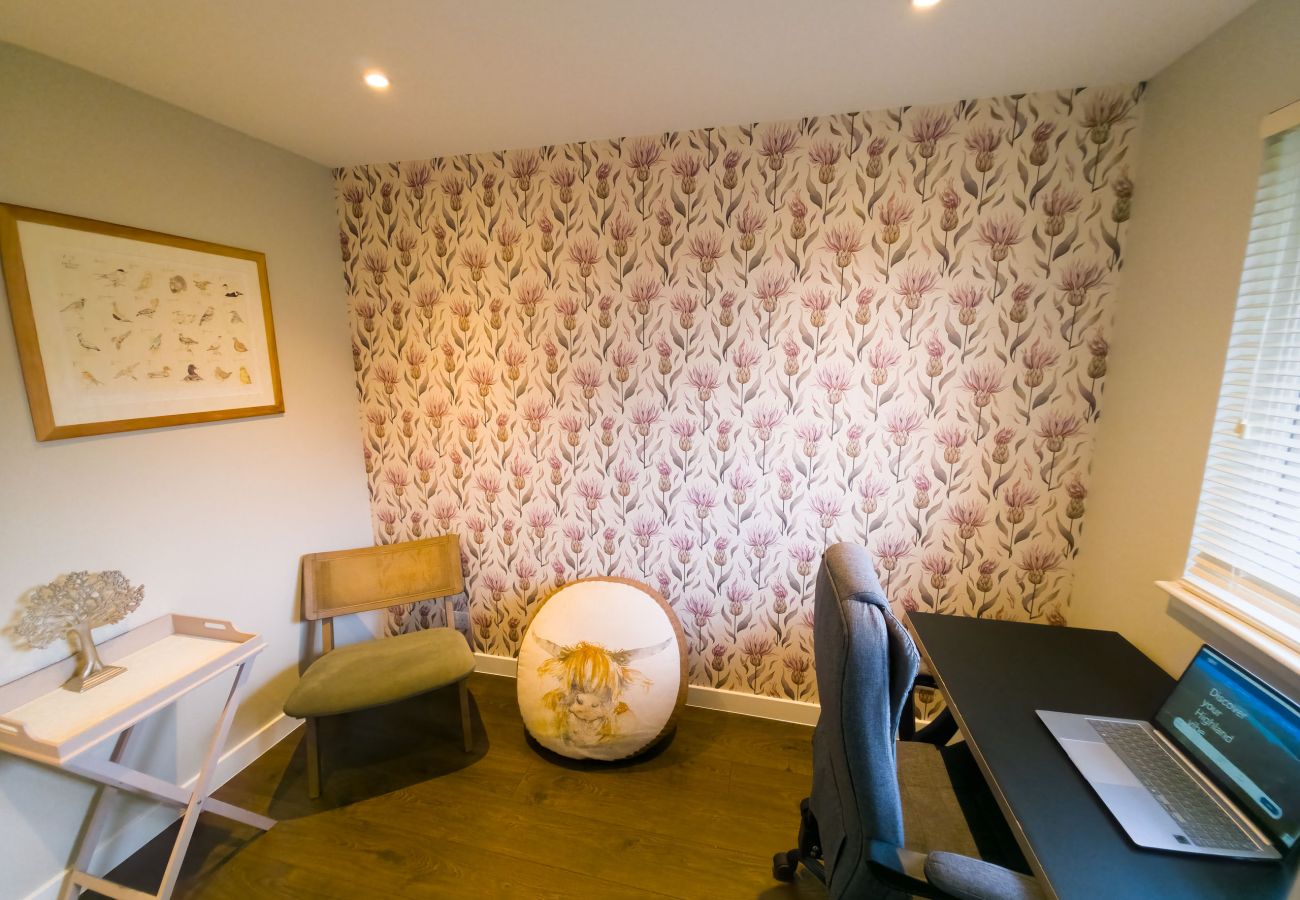 Dedicated desk area with a chair and laptop for working remotely.