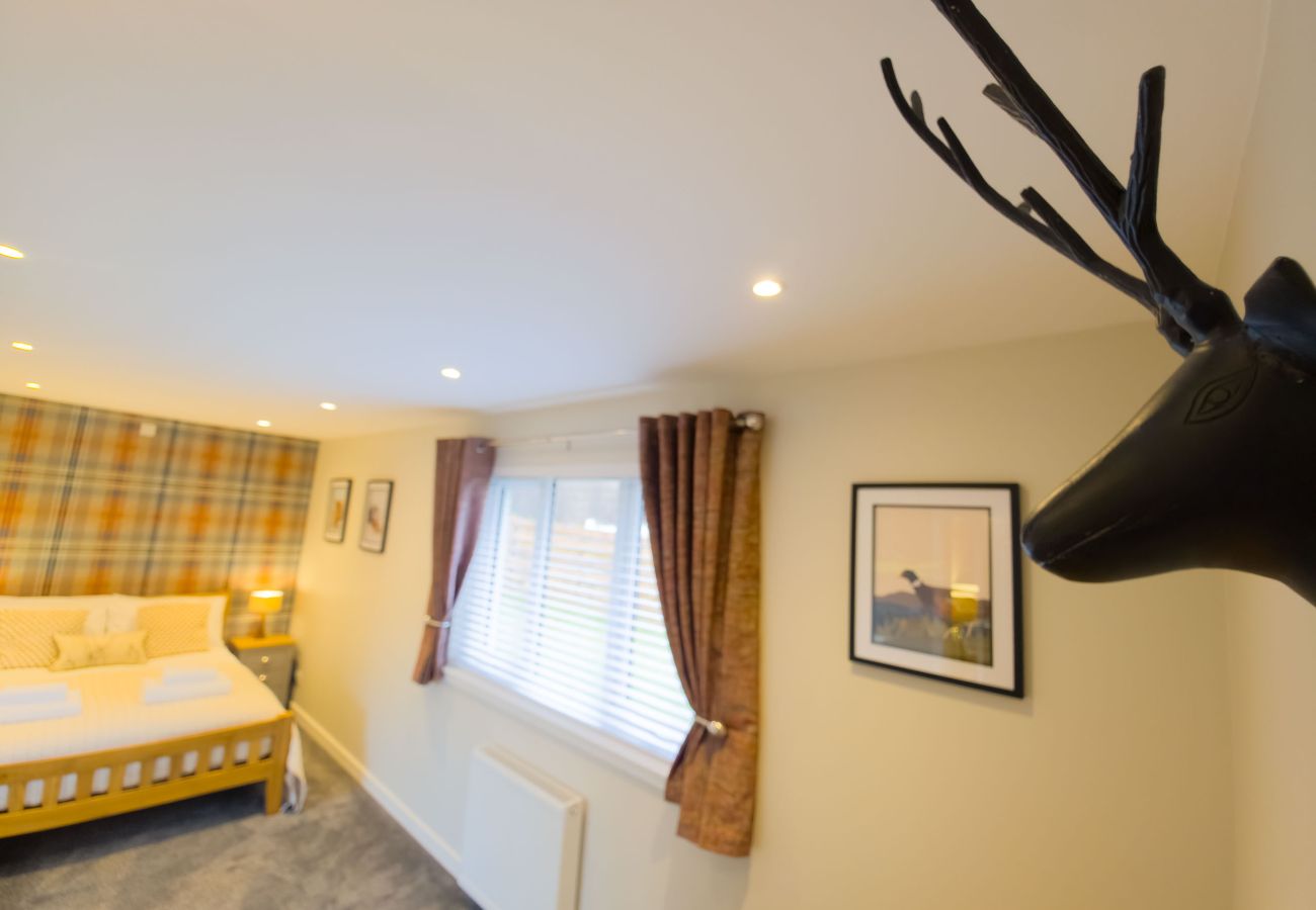 Comfortable double bedroom featuring traditional Scottish inspired decor