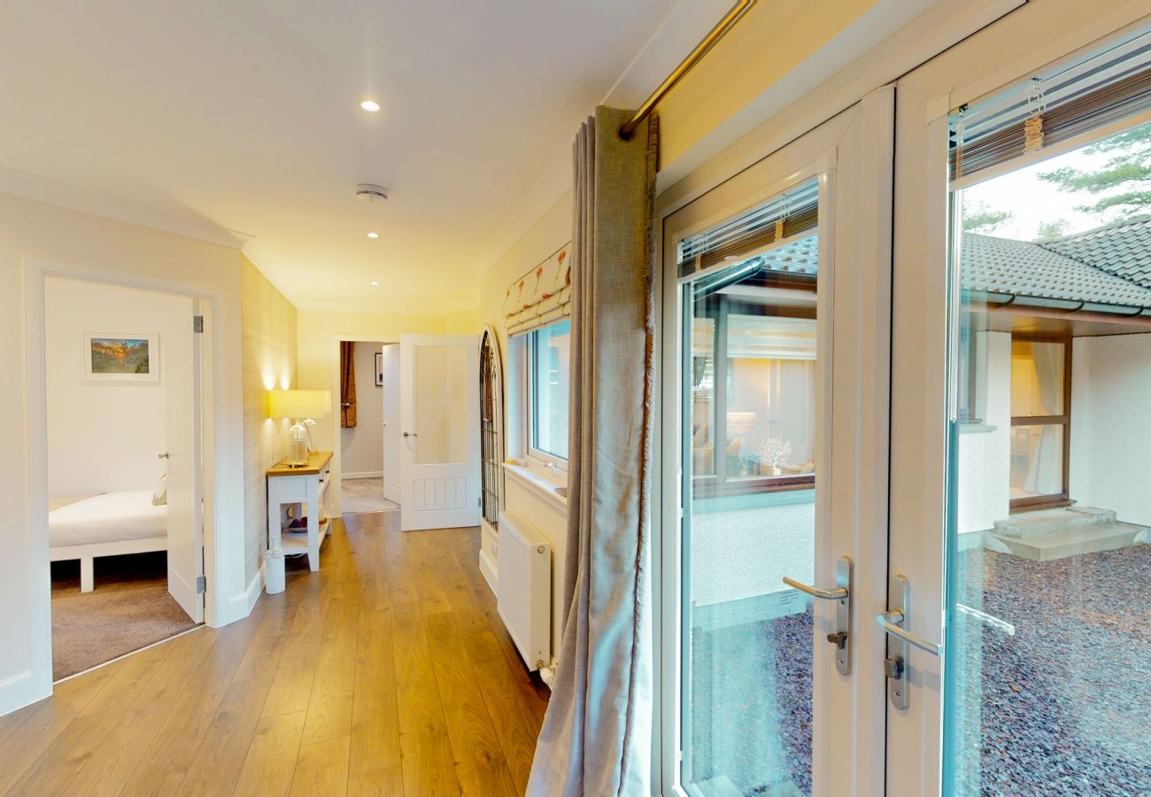 Connecting hallway inside the holiday lodge with bright natural light.