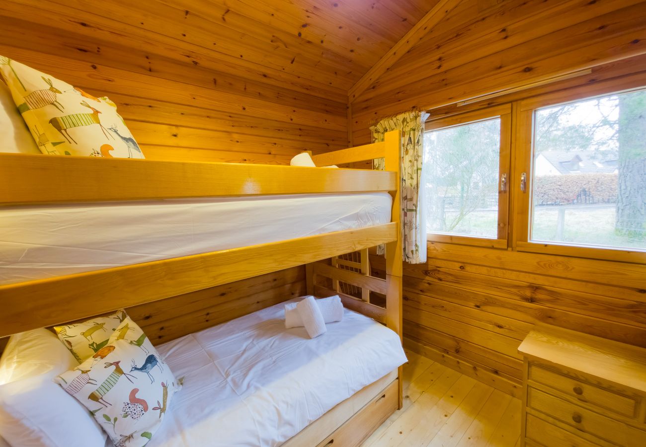 Cosy bunk bedroom styled for kids at Tormore wooden cabin
