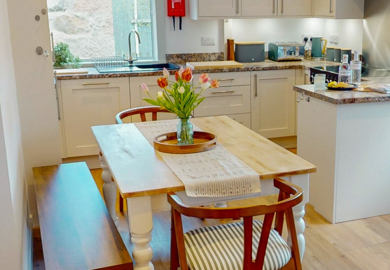 Kitchen-diner with white farmhouse dining table at Lynemore Croft