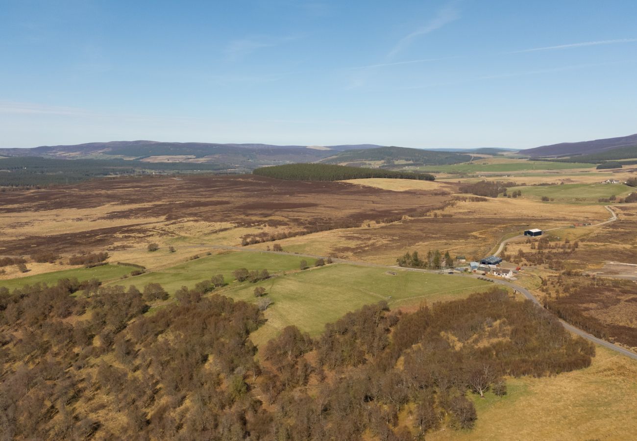 Drone aerial view of Highland moorland, farmland and forest near Lynemore Croft on the Grantown to Tomintoul road