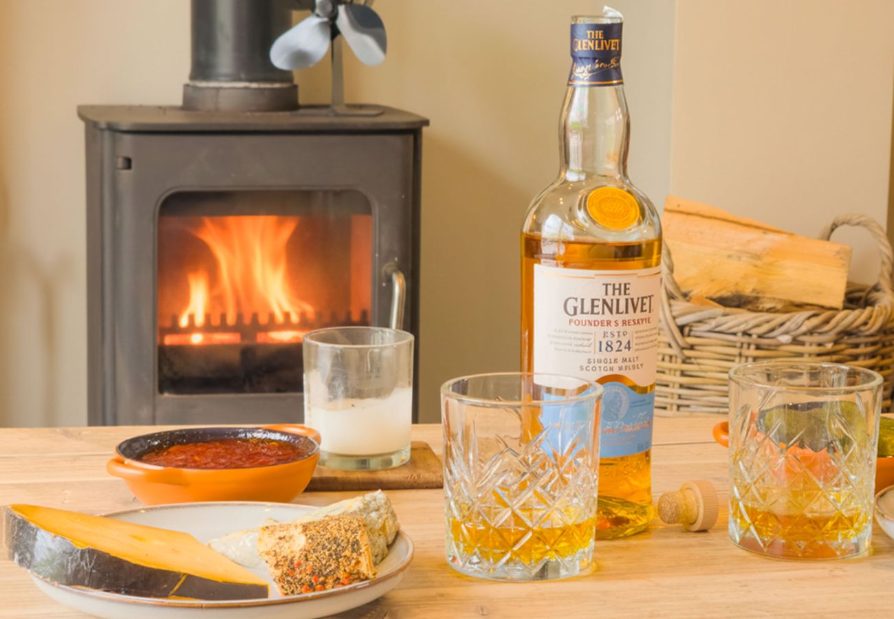 Log burner fireplace glowing at Betty's Cottage, Highland self-catering Scotland