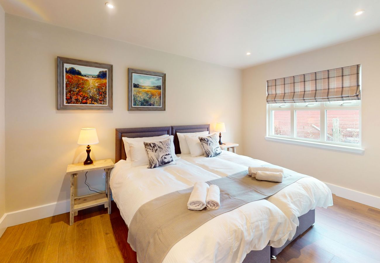 Double bedroom with Highland landscape artwork at Betty's Cottage Scottish Highlands