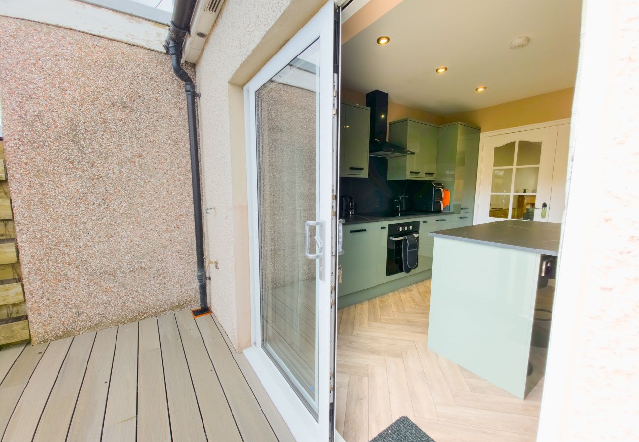 Private decking with sliding patio doors and kitchen view