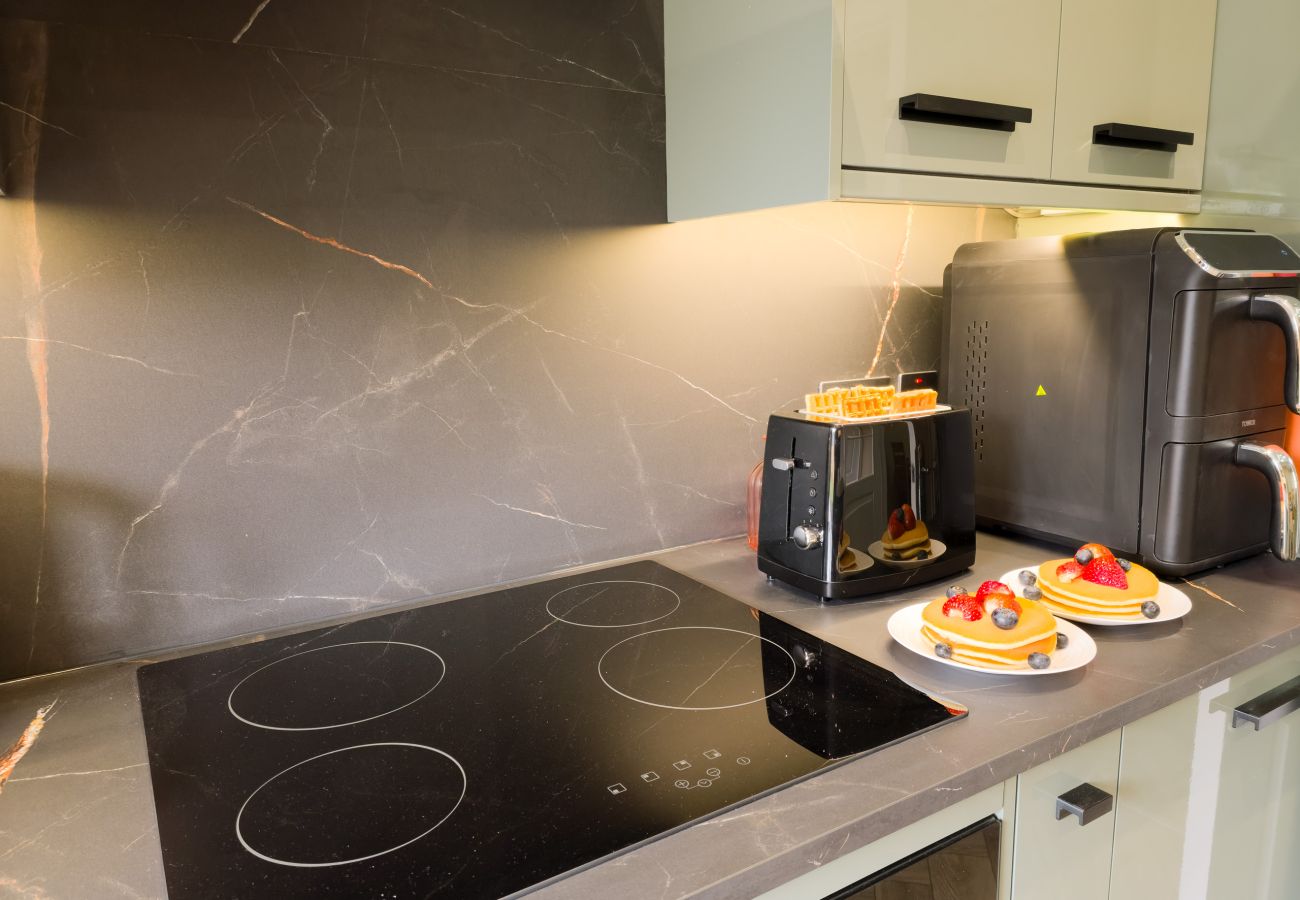 Induction hob on granite countertop in modern kitchen
