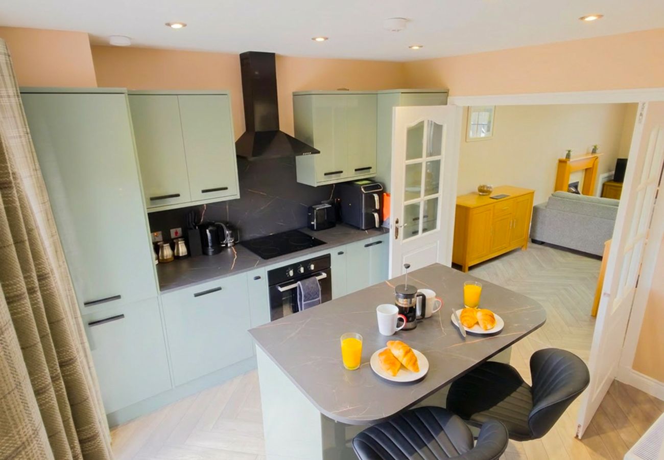Modern kitchen with green cabinetry and table