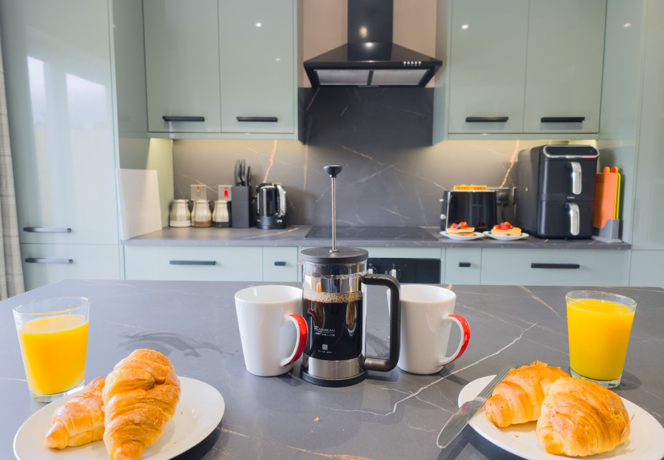 Sage green kitchen with coffee machine at Inverness self-catering holiday let