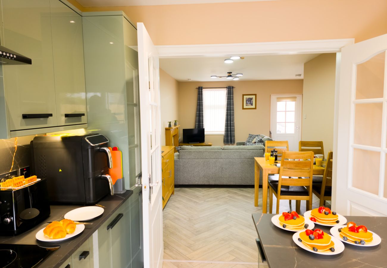 Open plan view of kitchen and living area at Inverness Crown holiday let