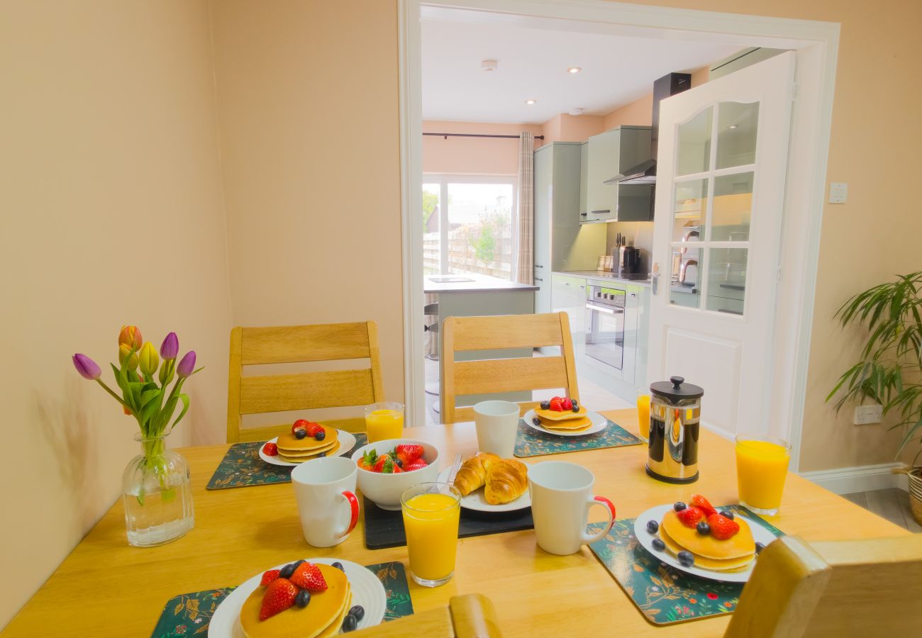Dining table set for breakfast near kitchen