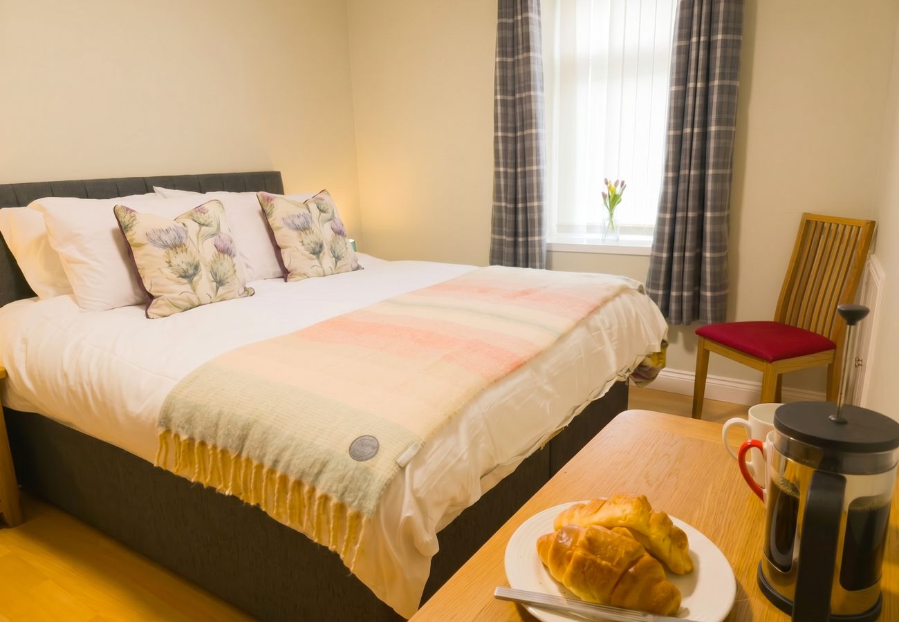 Double bedroom with soft pink bedding at 18 Hill Street Inverness holiday rental
