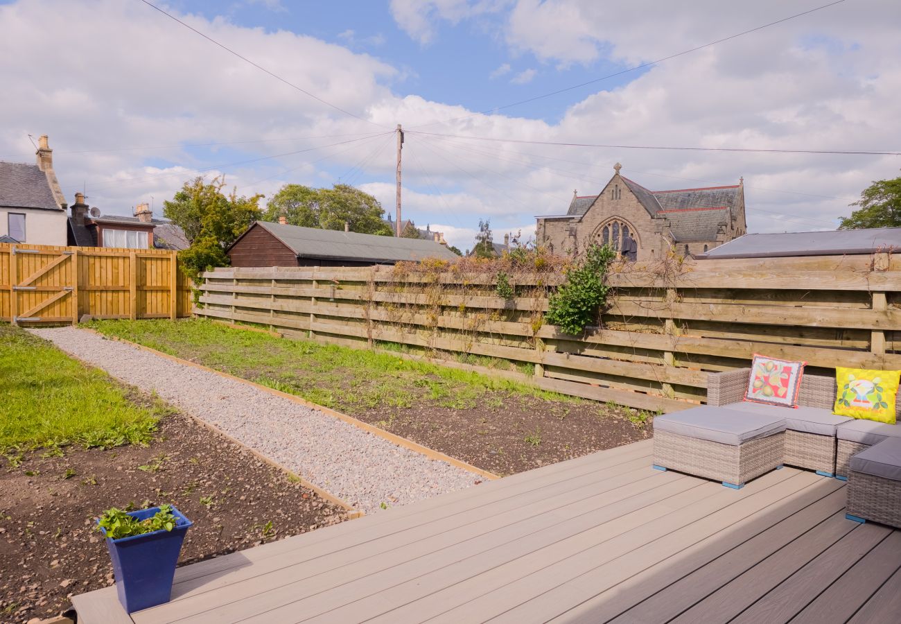 Private garden with decked terrace at 18 Hill Street self-catering cottage in the Crown area of Inverness