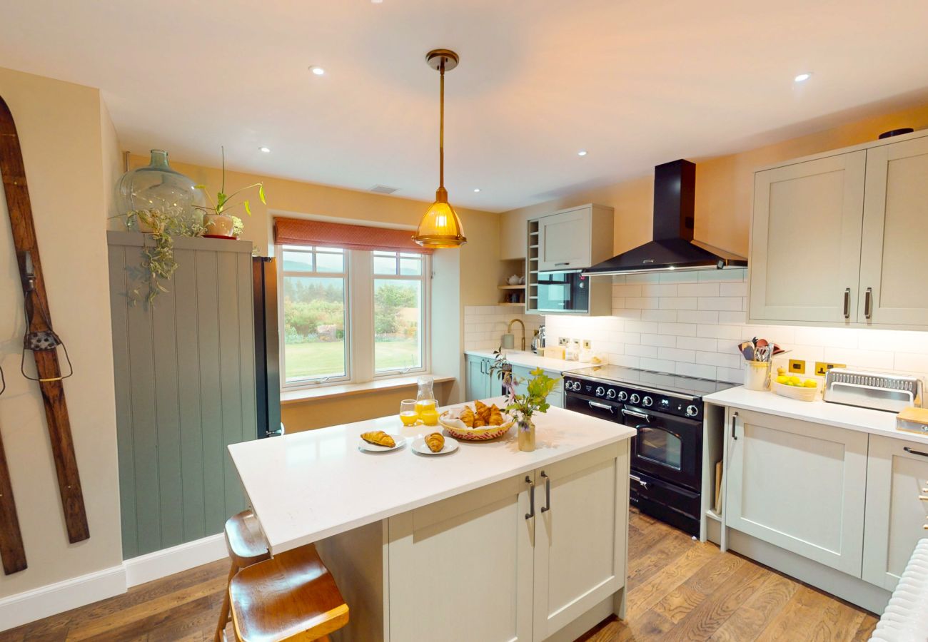 Bright kitchen with range cooker and island at Lynwilg House self-catering Highland holiday home
