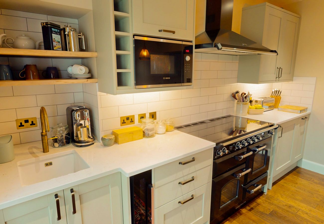 Kitchen with range cooker, open shelving and modern appliances at Lynwilg House Highland holiday home